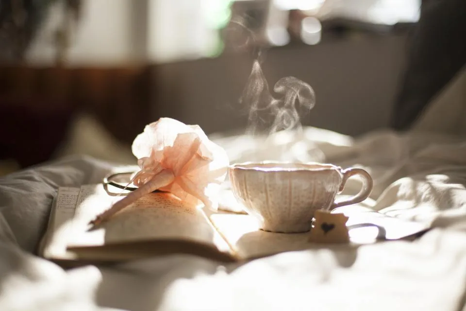 A tea table set for two with a photo album
